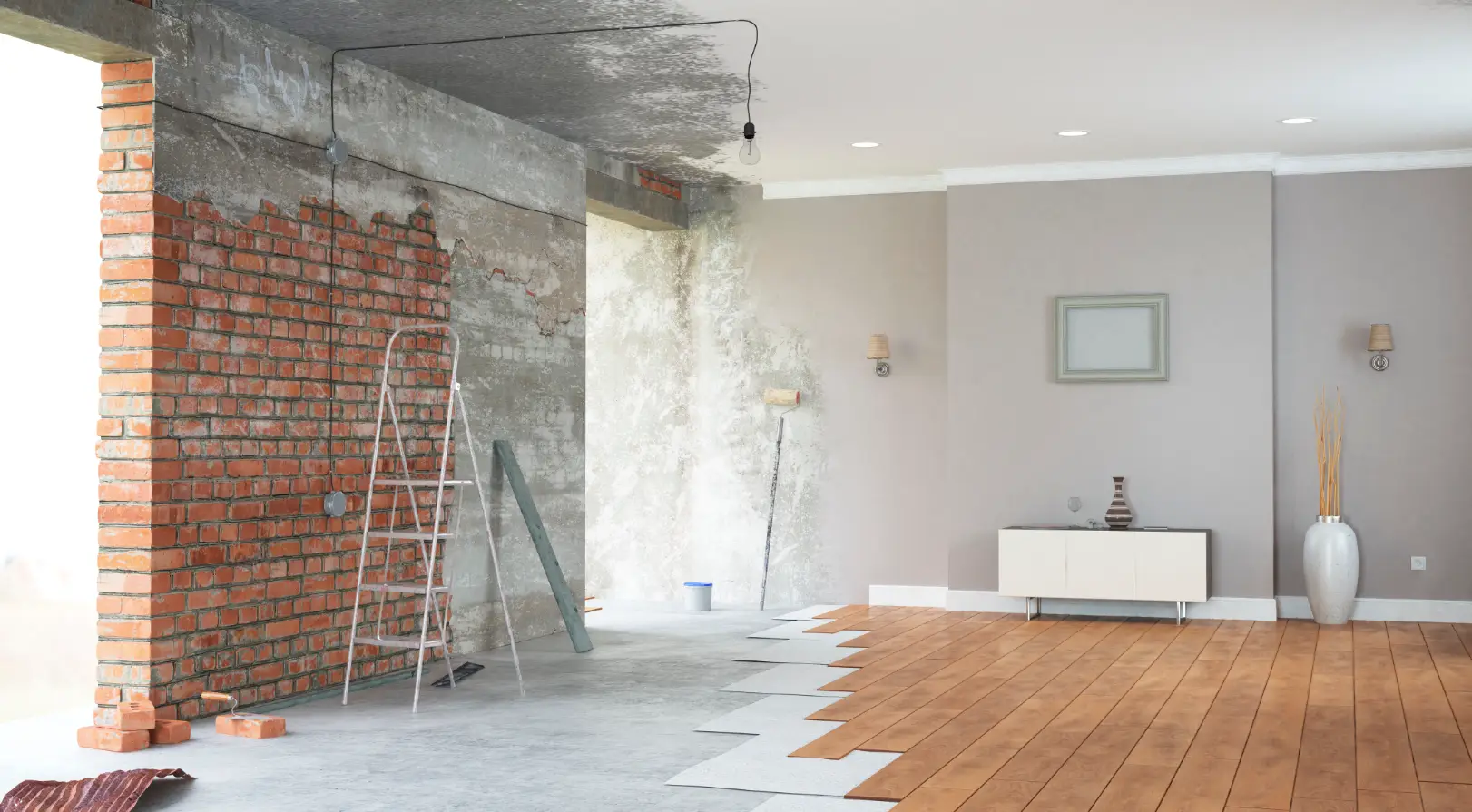 Interior renovation showing exposed brick wall, wall repairs, and new flooring installation.